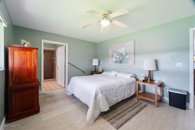 bedroom with light hardwood / wood-style flooring, connected bathroom, and ceiling fan