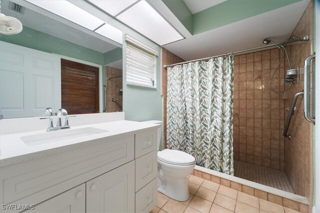 bathroom featuring vanity, tile patterned flooring, toilet, and a shower with shower curtain