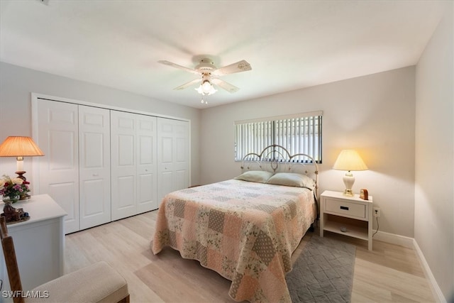 bedroom with light hardwood / wood-style flooring, a closet, and ceiling fan