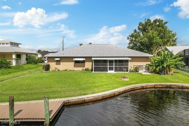 back of house featuring a water view and a yard