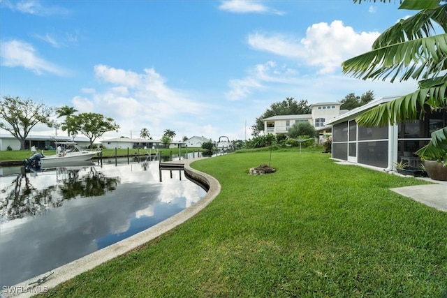 exterior space featuring a dock, a water view, and a sunroom