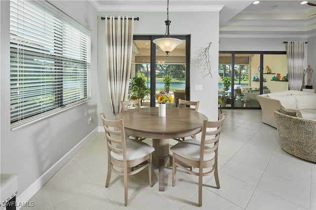 tiled dining space featuring ornamental molding and plenty of natural light