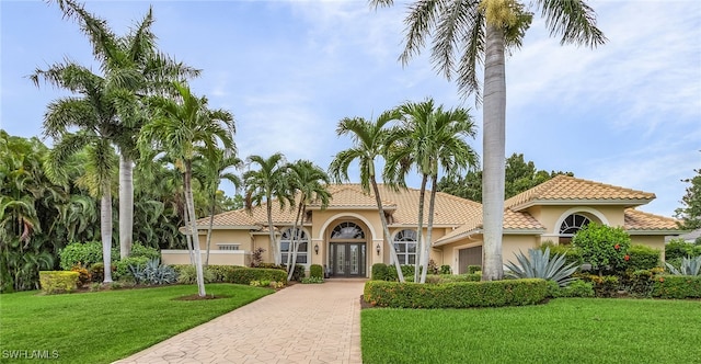 mediterranean / spanish home featuring a front yard