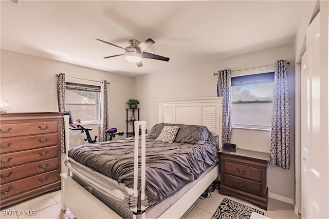 tiled bedroom with ceiling fan