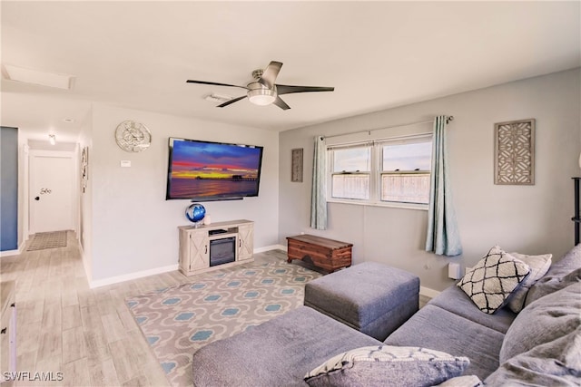 living room with light wood-type flooring and ceiling fan