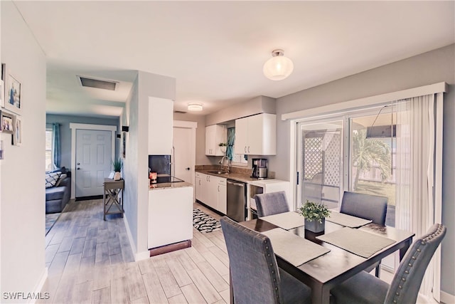 dining space featuring light hardwood / wood-style floors and sink