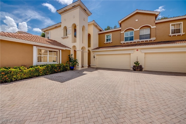 mediterranean / spanish-style house with a garage