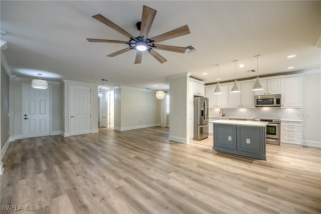 kitchen featuring white cabinetry, ceiling fan, stainless steel appliances, and decorative light fixtures