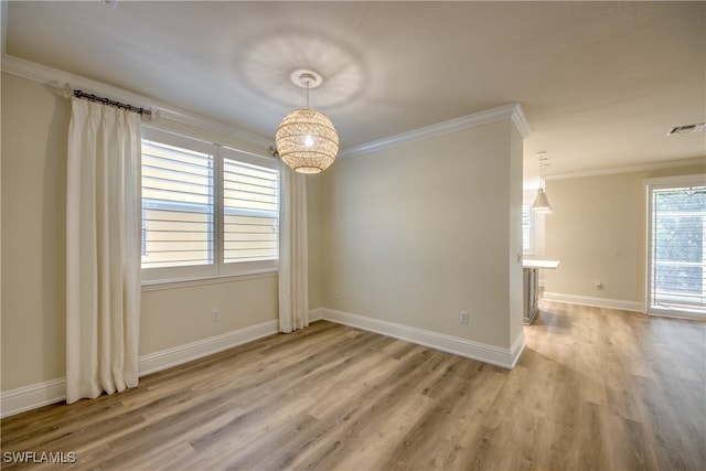 unfurnished room featuring ornamental molding and wood-type flooring