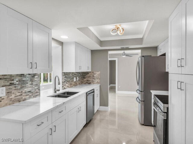 kitchen featuring white cabinets, ceiling fan, sink, and appliances with stainless steel finishes