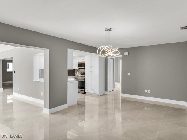 unfurnished dining area featuring a notable chandelier