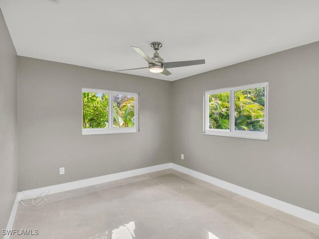 unfurnished room with a wealth of natural light and ceiling fan