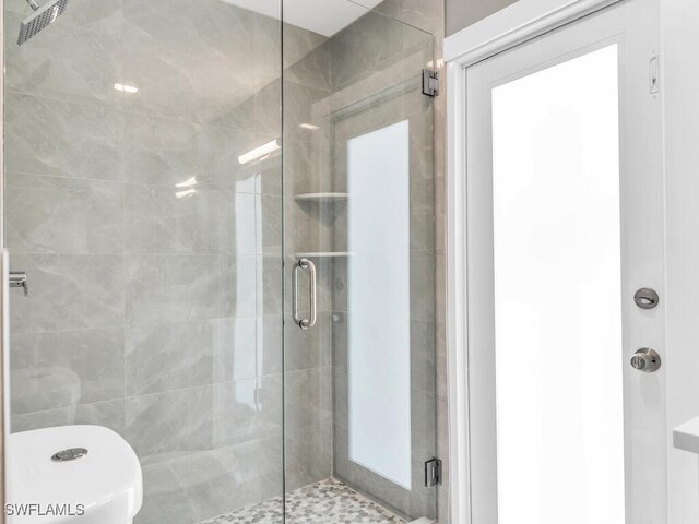 bathroom with a shower with door