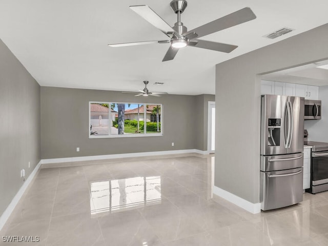 unfurnished living room with ceiling fan