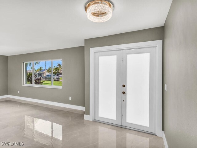 entryway featuring french doors and light tile patterned flooring