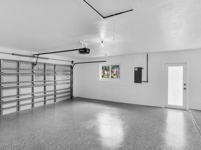 garage featuring electric panel and a garage door opener