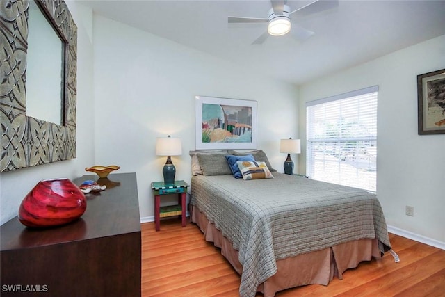 14850 Crystal Cove Ct Unit 402, Fort Myers, FL 33919 - bedroom with vaulted ceiling, baseboards, light wood-style floors, and ceiling fan