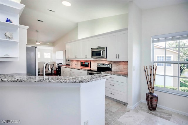 kitchen featuring kitchen peninsula, appliances with stainless steel finishes, and white cabinets