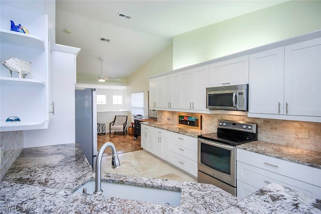 kitchen with stainless steel appliances, white cabinetry, and sink