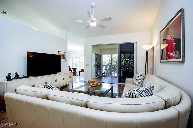 living room featuring ceiling fan, hardwood / wood-style flooring, and vaulted ceiling