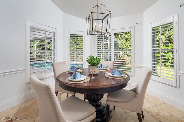 dining area featuring lofted ceiling, a chandelier, and a healthy amount of sunlight