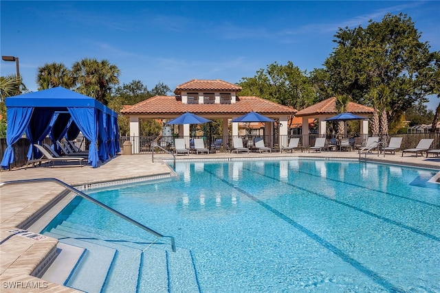 view of swimming pool featuring a gazebo and a patio