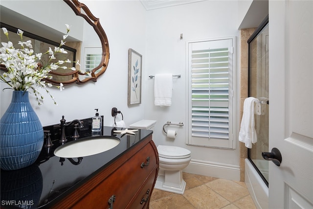 full bathroom featuring combined bath / shower with glass door, vanity, toilet, and tile patterned floors