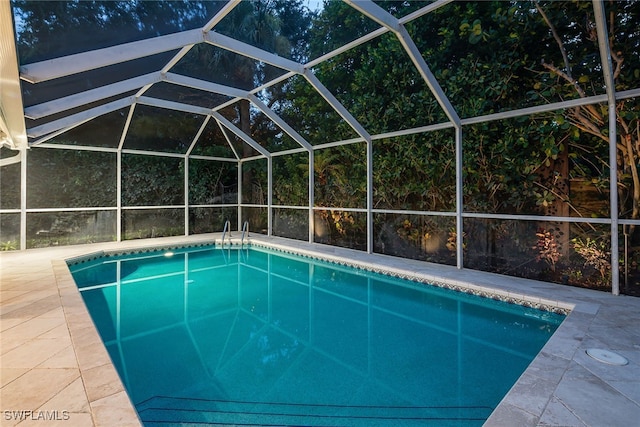 view of pool with a patio and a lanai