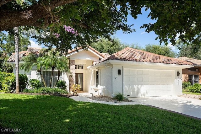 mediterranean / spanish-style home featuring a garage and a front lawn