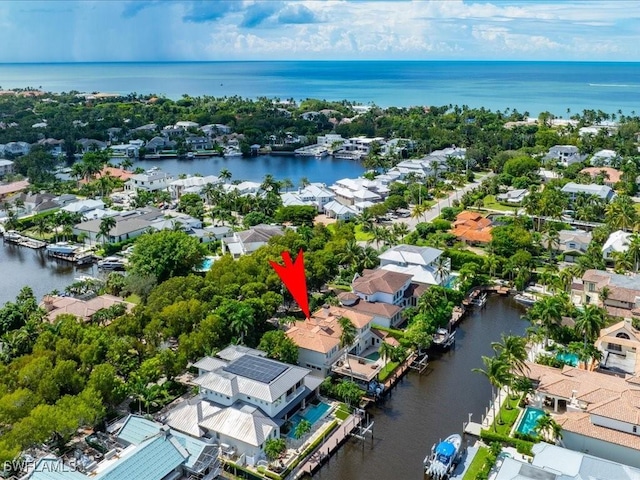 birds eye view of property with a water view