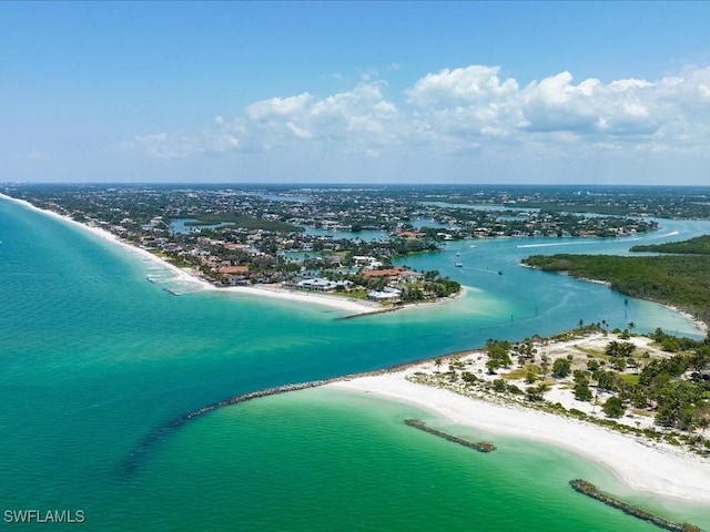 bird's eye view featuring a water view and a beach view