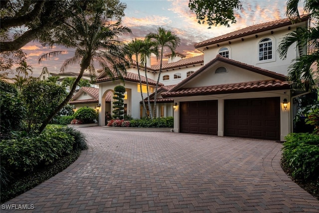 mediterranean / spanish home featuring a garage