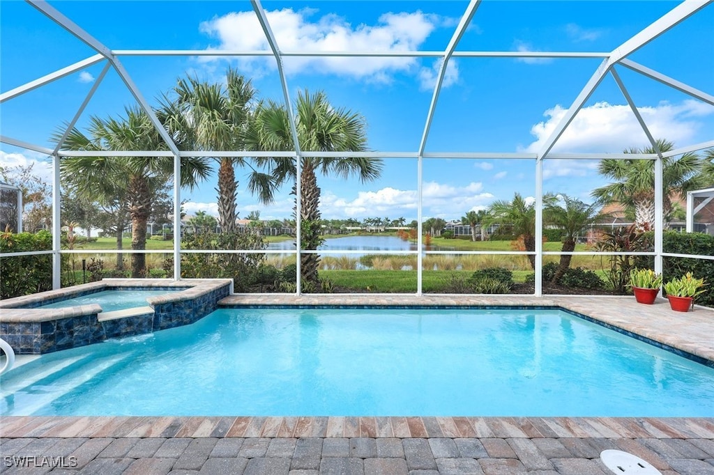 view of swimming pool with a lanai, an in ground hot tub, and a water view