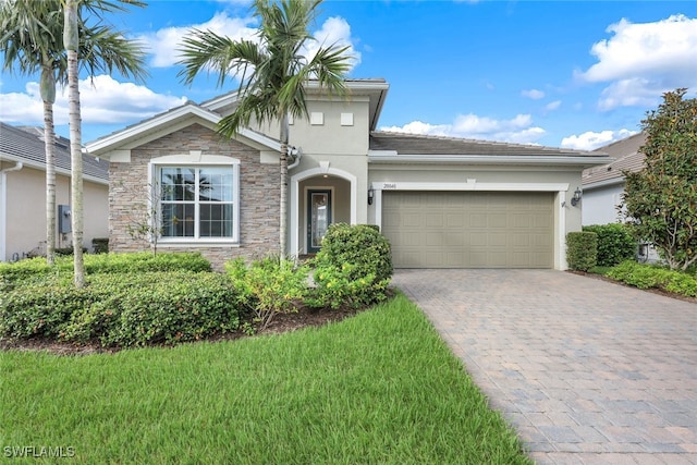 view of front of property with a garage and a front lawn