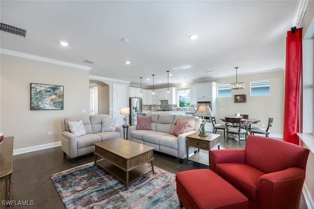 living room with dark wood-type flooring and ornamental molding