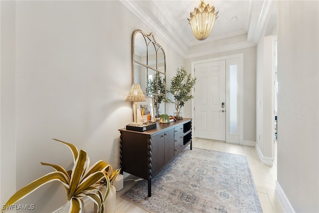 foyer featuring a healthy amount of sunlight, ornamental molding, and an inviting chandelier