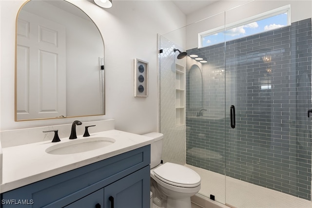 bathroom with vanity, toilet, and walk in shower