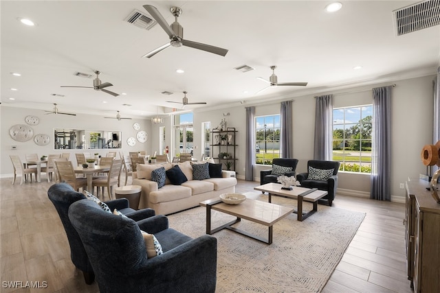 living room featuring light hardwood / wood-style flooring and crown molding