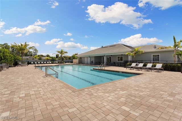 view of pool with ceiling fan and a patio