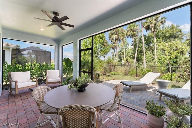 sunroom / solarium featuring ceiling fan