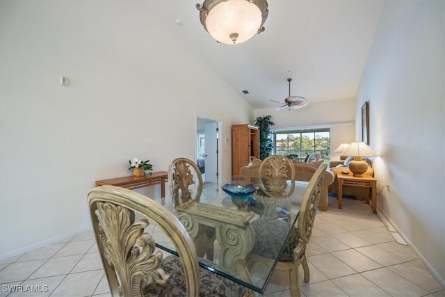 dining space featuring high vaulted ceiling, light tile patterned flooring, ceiling fan, and baseboards