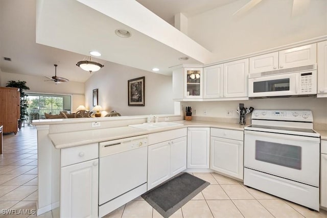 kitchen featuring sink, white cabinetry, light tile patterned floors, kitchen peninsula, and white appliances