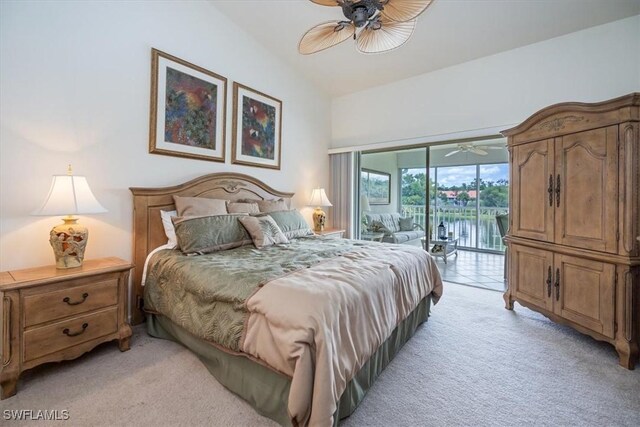 carpeted bedroom featuring lofted ceiling, access to exterior, and ceiling fan