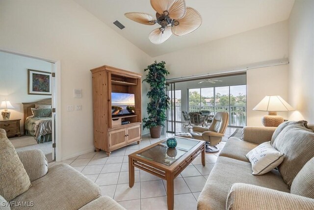 tiled living room featuring ceiling fan and high vaulted ceiling