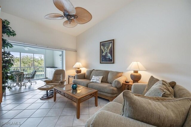 tiled living room with ceiling fan and high vaulted ceiling