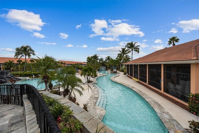 community pool featuring a sunroom