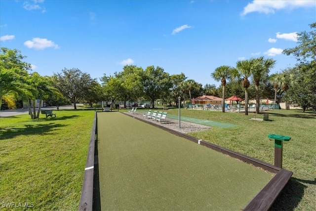 view of property's community featuring a yard