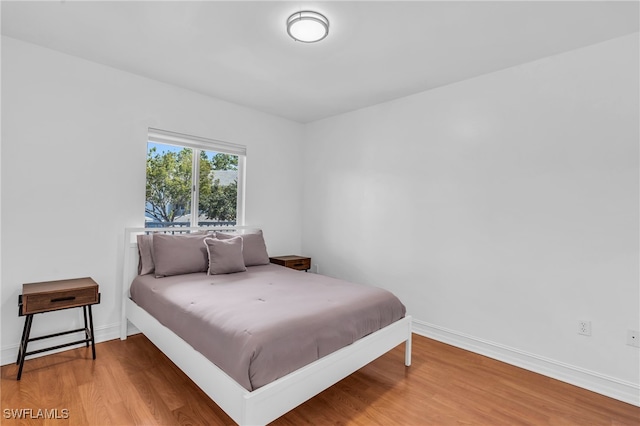 bedroom with hardwood / wood-style flooring