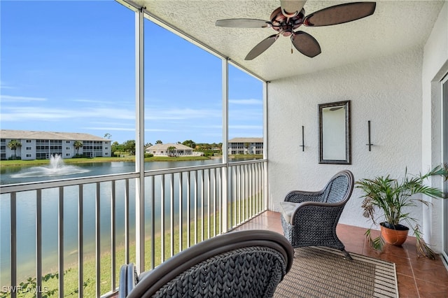 sunroom / solarium with a water view and ceiling fan