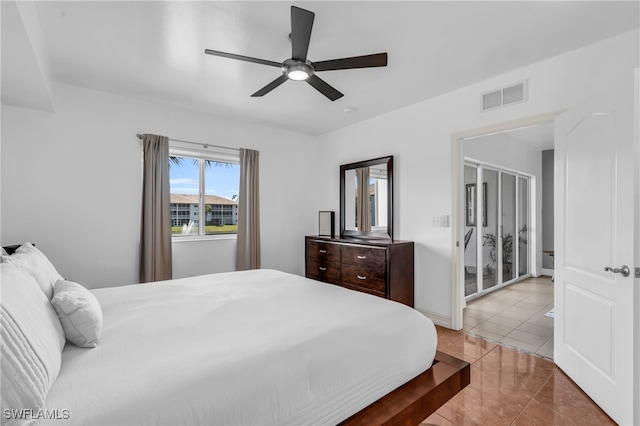 tiled bedroom with ceiling fan